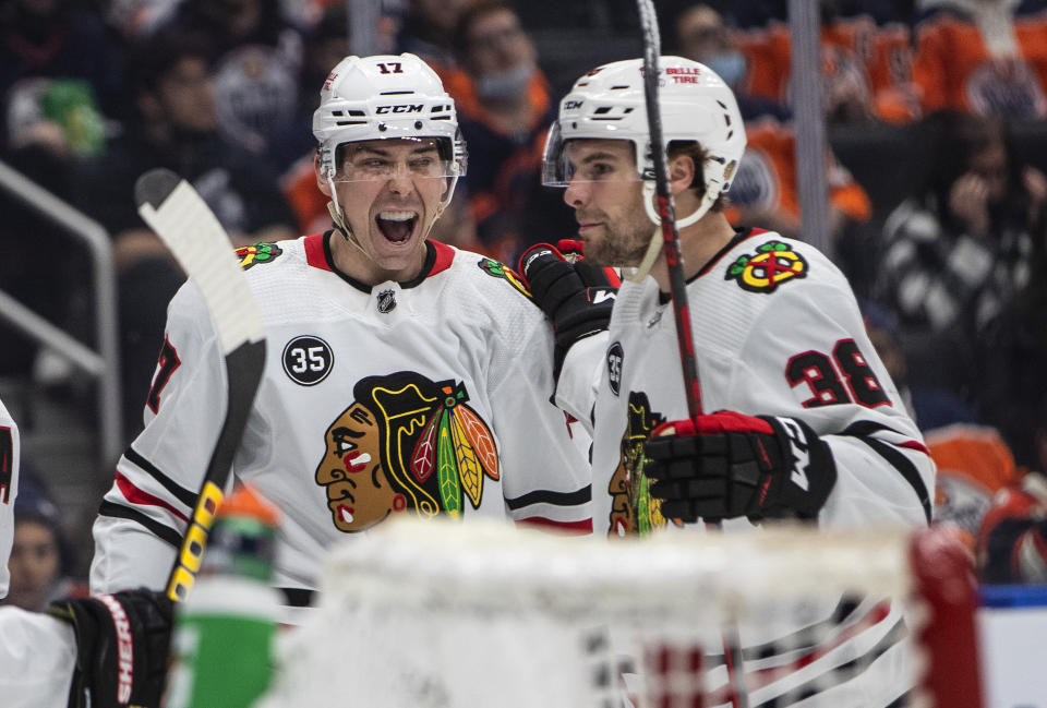Chicago Blackhawks' Dylan Strome (17) and Brandon Hagel (38) celebrate a goal against the Edmonton Oilers during the third period of an NHL hockey game Wednesday, Feb. 9, 2022, in Edmonton, Alberta. (Jason Franson/The Canadian Press via AP)