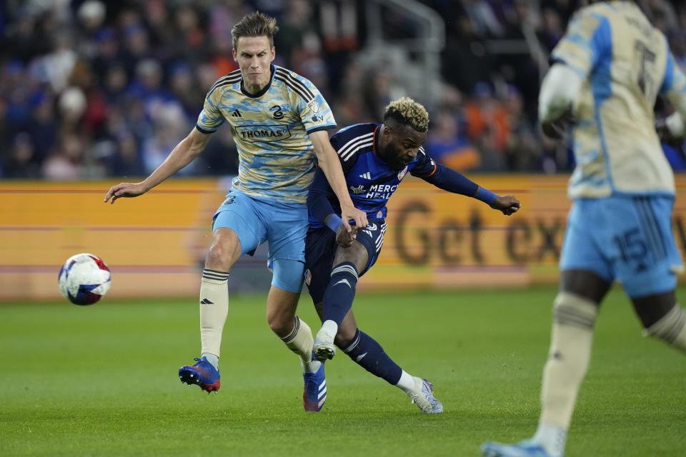 Philadelphia Union defender Jack Elliott (3) and FC Cincinnati forward Aaron Boupendza (9) battle for the ball during the first half of an MLS Eastern Conference semifinals playoff soccer match, Saturday, Nov. 25, 2023, in Cincinnati. (AP Photo/Carolyn Kaster)