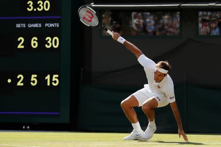 Tennis - Wimbledon - All England Lawn Tennis and Croquet Club, London, Britain - July 11, 2018. Switzerland's Roger Federer slips during his quarter final match against South Africa's Kevin Anderson. REUTERS/Andrew Boyers