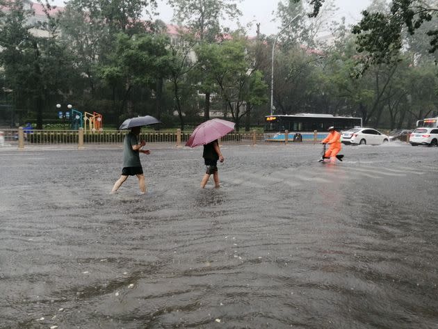 BEIJING, CHINA - JULY 31, 2023 - Citizens travel during heavy rain in Beijing, China, July 31, 2023. (Photo by Costfoto/NurPhoto via Getty Images)