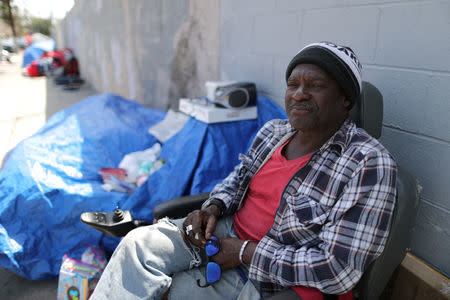 Cedric Sweeting, 63, who has been homeless for a year, sits next to his tent in Hollywood, Los Angeles, California, U.S. April 13, 2018. Picture taken April 13, 2018. REUTERS/Lucy Nicholson