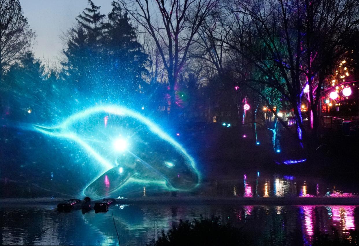 March 21, 2024; Powell, Ohio, USA; 
Animals are projected in the fountains on the lake at the Columbus Zoo and Aquarium during UNEXTINCT.

UNEXTINCT is an outdoor, nighttime immersive event at the Columbus Zoo and Aquarium that brings seventy extinct and endangered species life in fifteen areas around the zoo using tech-based illusions to teach about extinction and conservation.