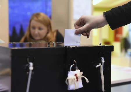 A woman casts her vote in a polling station at St Anthonys School in Castlebar, Ireland February 26, 2016. REUTERS/Clodagh Kilcoyne