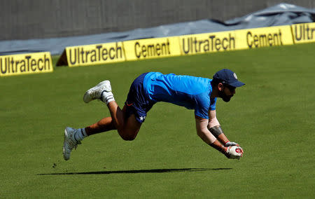 Cricket - India v Australia - India team practice session - M Chinnaswamy Stadium, Bengaluru, India - 03/03/17 - India's captain Virat Kohli dives to catch a ball during a practice session ahead of their second test match. REUTERS/Danish Siddiqui