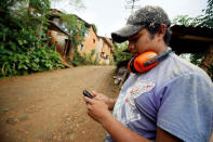 A carpenter writes a text mesage using the community-run phone network in Santa Maria Yaviche, in Oaxaca state, Mexico, September 26, 2016. Picture taken September 26, 2016. REUTERS/Jorge Luis Plata