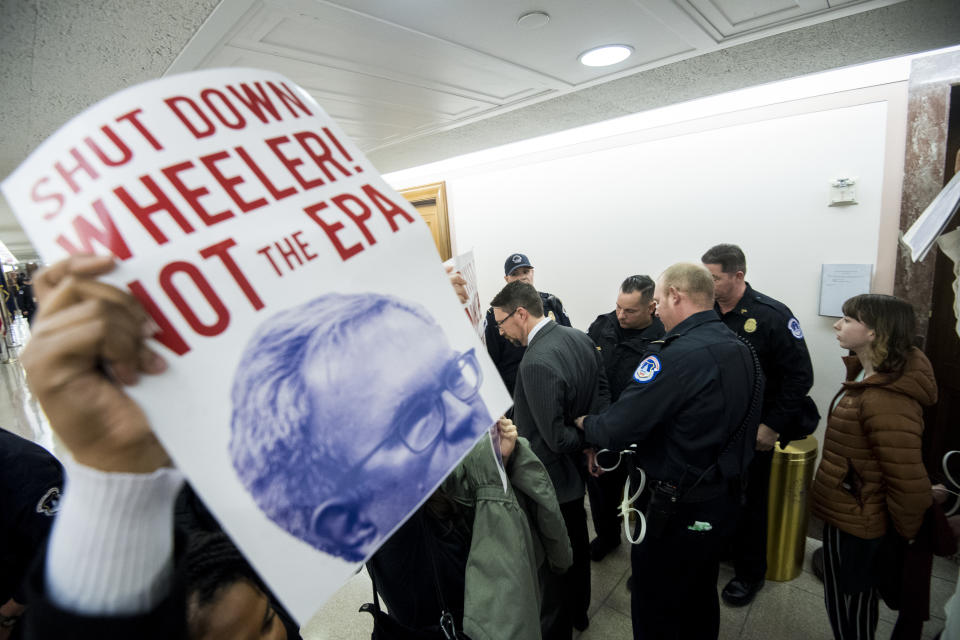 Several protesters are arrested by Capitol Police after being pulled out of the confirmation hearing for Andrew Wheeler to be administrator of the Environmental Protection Agency in the Senate Environment and Public Works Committee on Jan. 16, 2019. (Photo: Bill Clark/CQ Roll Call/Getty Images)