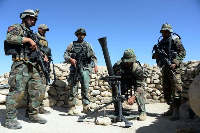 Afghan commandos prepare to launch mortar shells on an Islamic State (IS) militant stronghold in Achin district of Nangarhar