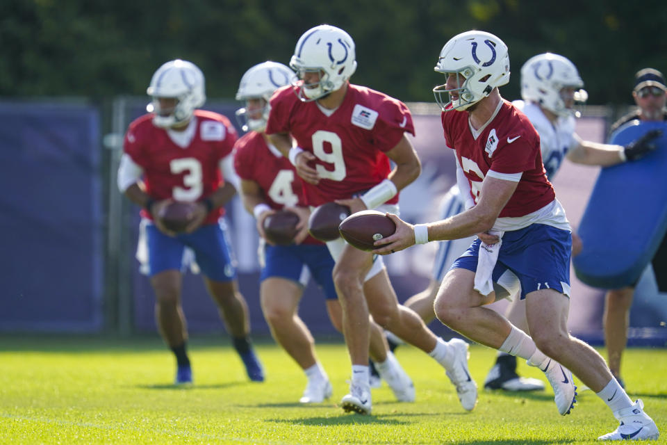 Indianapolis Colts quarterback Carson Wentz (2), along with fellow quarterbacks Jacob Eason (9), Sam Ehlinger (4), and Brett Hundley (3) run a drill during practice at the NFL team's football training camp in Westfield, Ind., Monday, Aug. 23, 2021. (AP Photo/Michael Conroy)