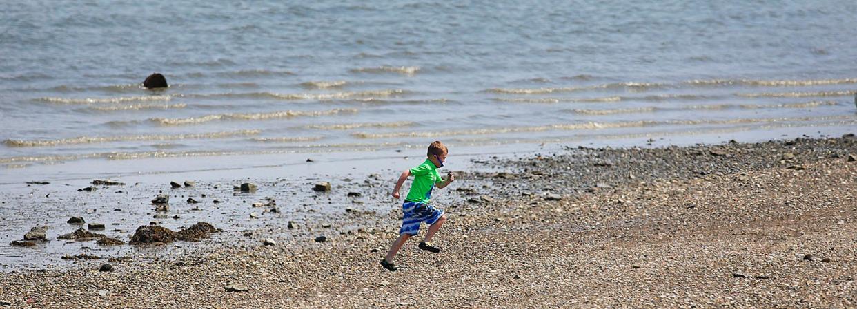 A child plays at Orchard Beach in Squantum.