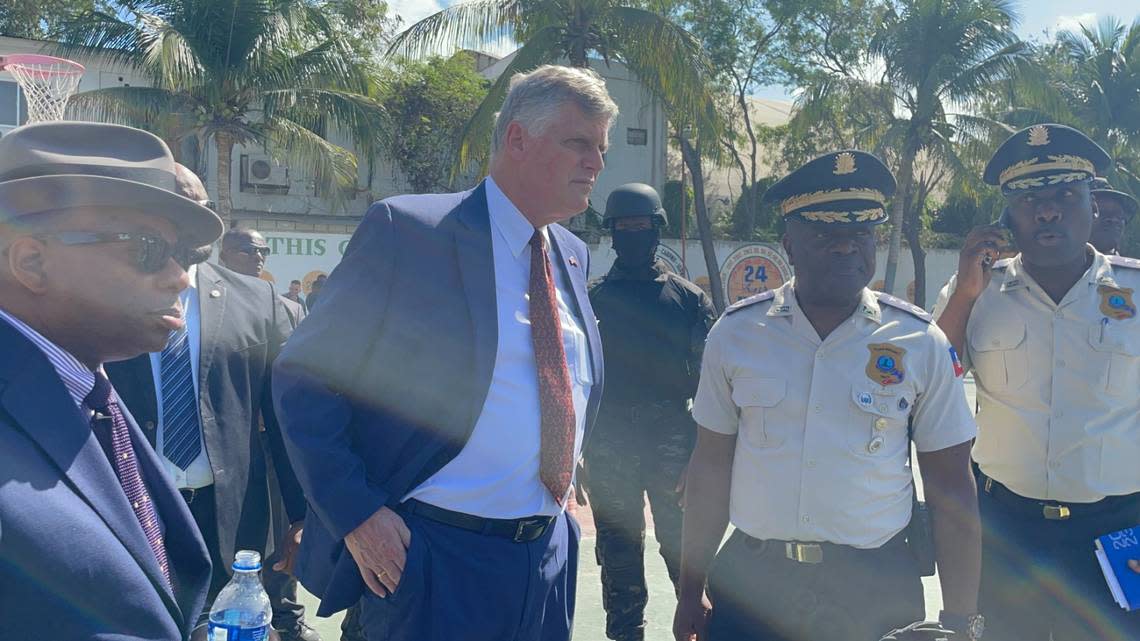Todd Robinson, assistant secretary of state in charge of the Bureau of International Narcotics and Law Enforcement Affairs, left, stands next to U.S. Chargé d’Affaires Eric Stromayer as they visit a U.S.-financed SWAT training at the Haiti National police training grounds. They are joined by Haiti National Police Chief Frantz Elbé and an aide during the Friday, Jan. 27, 2023, visit in Port-au-Prince, Haiti.