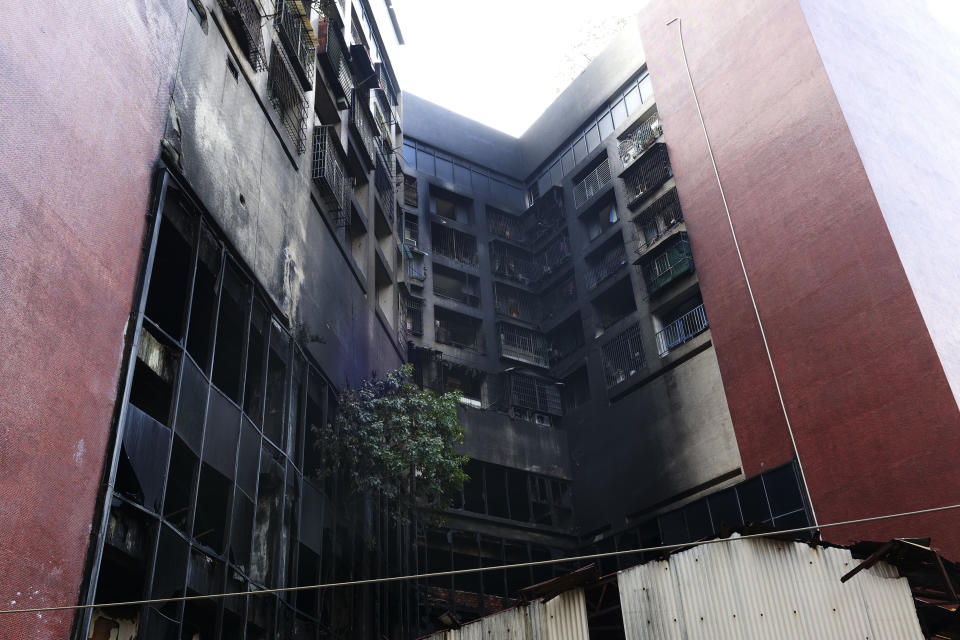 A charred building sits empty after a major fire in Kaohsiung, southern Taiwan, Friday, Oct. 15, 2021. Taiwanese officials set up an independent commission Friday to investigate the conditions at a run-down building in the port city of Kaohsiung where a fire killed over forty people, while authorities scoured the blackened ruins for the cause of the blaze. (AP Photo/Huizhong Wu)