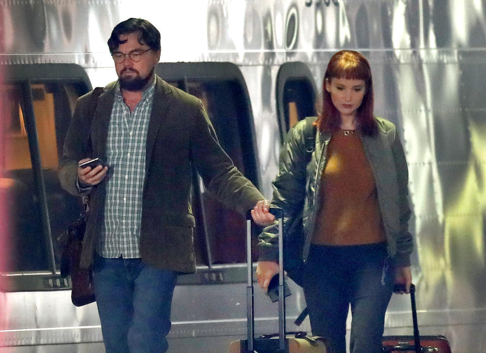 BOSTON, MA - DECEMBER 1: Actors Leonardo DiCaprio and Jennifer Lawrence walk along the train platform next to an Acela train at South Station during on location filming of "Don't Look Up" at South Station in Boston on Dec. 1, 2020. The film stars Jennifer Lawrence, Leonardo DiCaprio, Meryl Streep, and is directed by Adam McKay. (Photo by David L. Ryan/The Boston Globe via Getty Images)