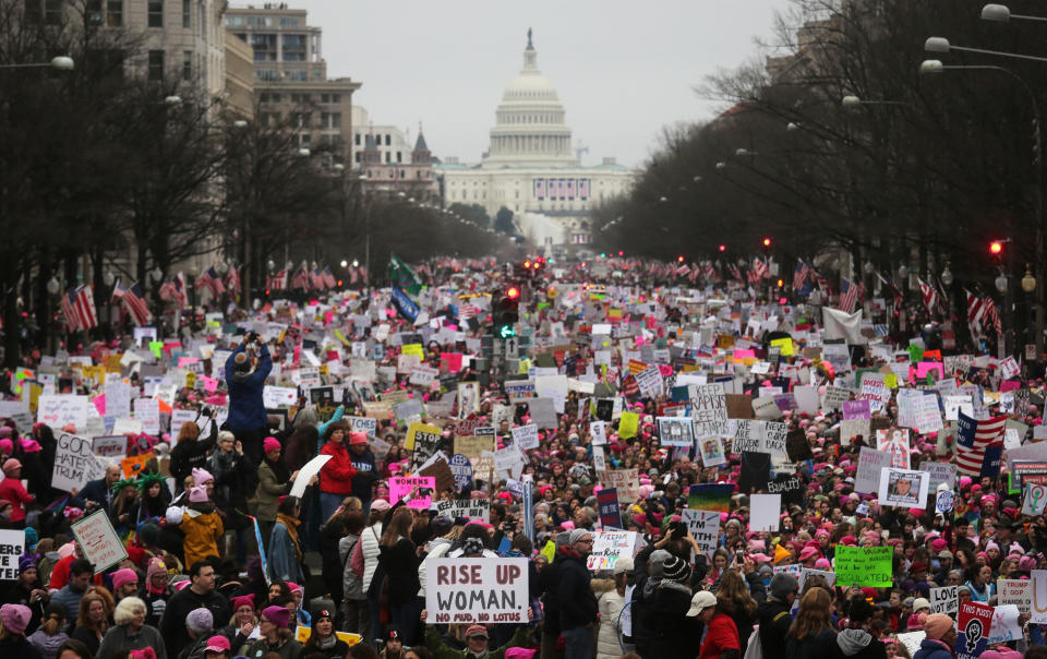 Protesters walk during the Women's March on Washington, with the U.S. Capitol in the background, on January 21, 2017 in Washington, DC.