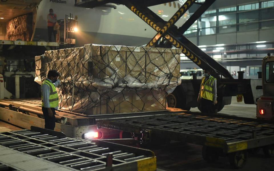 In this handout photograph taken taken on April 27, 2021 and released by the Foreign, Commonwealth and Development Office shows ground staff unloading medical aid from an aircart sent from the United Kingdom upon its arrival at an airport, in New Delhi.  - Foreign, Commonwealth & Developm/AFP via Getty Images