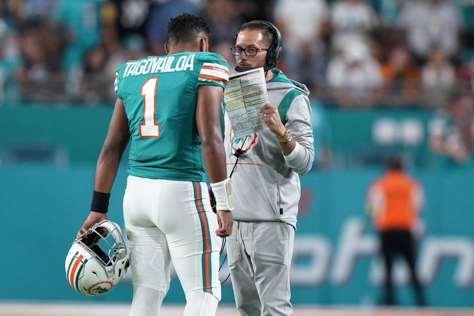 Miami Dolphins head coach Mike McDaniel talks to quarterback Tua Tagovailoa (1) during the first half of an NFL football game against the Pittsburgh Steelers, Sunday, Oct. 23, 2022, in Miami Gardens, Fla. (AP Photo/Wilfredo Lee )