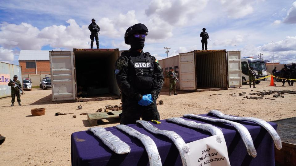 Bolivian police guard cocaine seized from two shipping containers that was hidden in scrap metal, during a news conference by Interior Minister Eduardo del Castillo in Bolivia's Pisiga region, near the border with Chile, March 18, 2024. / Credit: Facebook/Interior Ministry of Bolivia