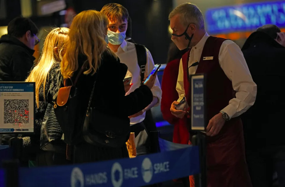 People show their vaccine passes for Les Miserables at the Sondheim Theatre in London. (PA)