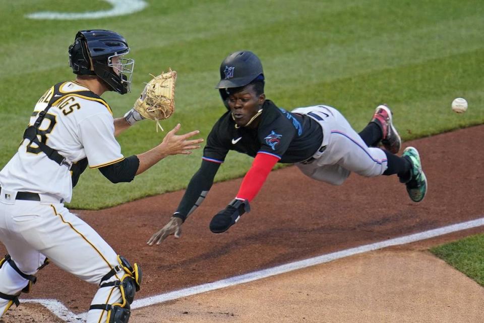 Pittsburgh Pirates catcher Jacob Stallings, left, takes the toss to get the force out at home plate on Miami Marlins’ Jazz Chisholm Jr. who was attempting to score on a fielder’s choice by Cody Poteet back to Pirates pitcher Mitch Keller during the second inning of a baseball game in Pittsburgh, June 4, 2021.