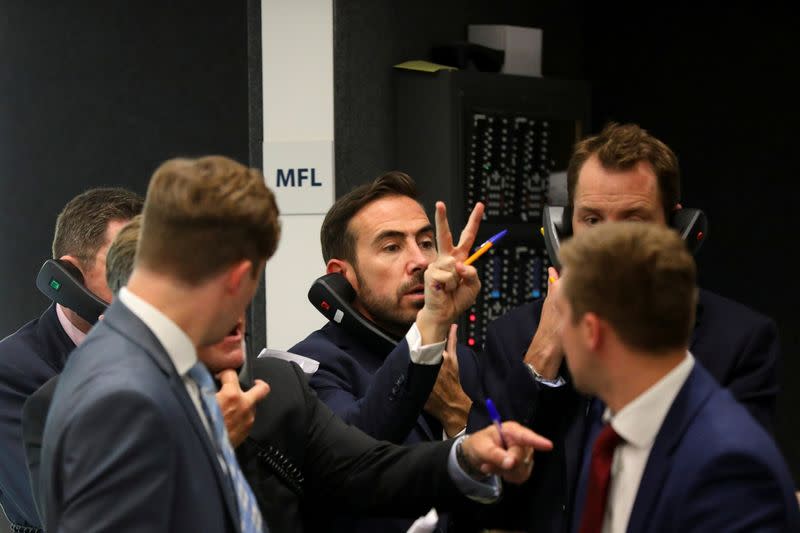 FILE PHOTO: Traders work on the floor of the London Metal Exchange, in London