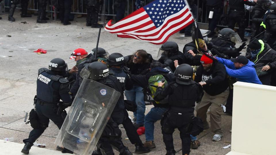 Trump supporters clash with police and security forces as they storm the US Capitol in Washington D.C on January 6, 2021. - Demonstrators breeched security and entered the Capitol as Congress debated the a 2020 presidential election Electoral Vote Certification.