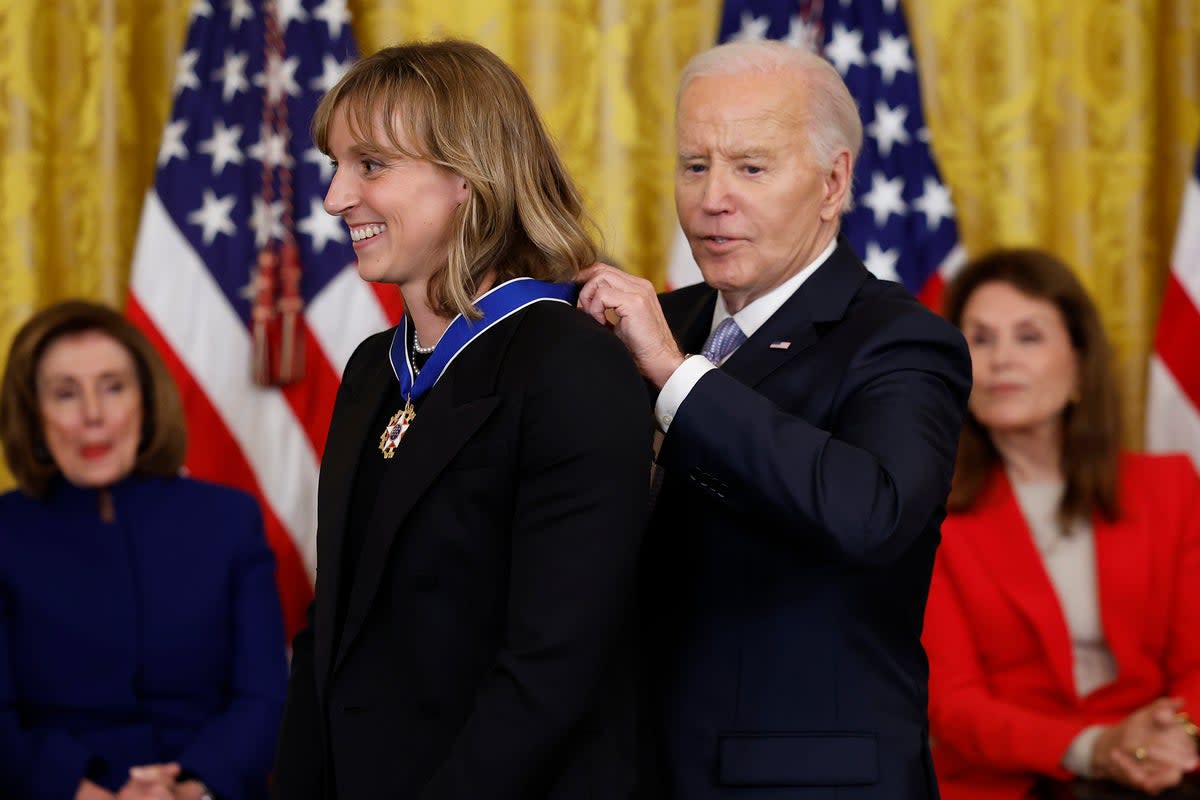 Joe Biden awards the Medal of Freedom to US Olympic gold medal swimmer Katie Ledecky during a ceremony in the East Room of the White House on May 3, 2024 (Getty Images)