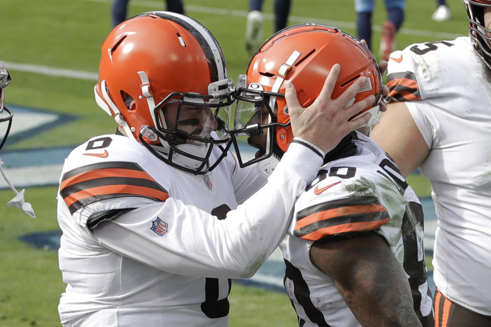 Cleveland Browns quarterback Baker Mayfield (6) congratulates wide receiver Jarvis Landry (80) after they teamed up for a touchdown pass against the Tennessee Titans in the first half of an NFL football game Sunday, Dec. 6, 2020, in Nashville, Tenn. (AP Photo/Ben Margot)