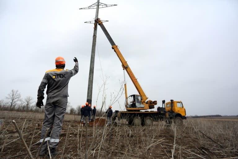 Workers repair power lines damaged by shelling between Ukrainian forces and the Russian-backed rebels near the government-held town Avdiivka, Donetsk region, on March 27, 2017