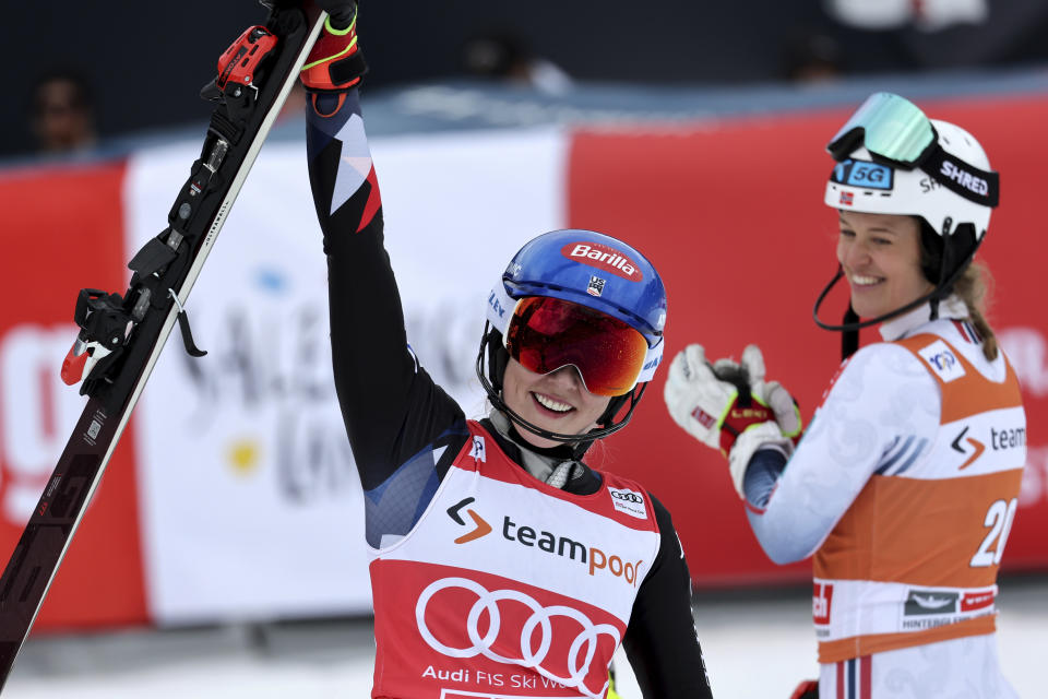 United States' Mikaela Shiffrin celebrates winning an alpine ski, women's World Cup slalom race, in Saalbach, Austria, Saturday, March 16, 2024. At right is second-placed Norway's Mina Fuerst Holtmann. (AP Photo/Marco Trovati)