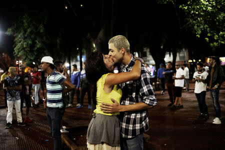 Safira, 25, who is among members of lesbian, gay, bisexual and transgender (LGBT) community, kisses a man during an event of Arouchianos collective project at Arouche Square in downtown Sao Paulo, Brazil, November 6, 2016. REUTERS/Nacho Doce