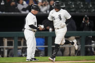 Chicago White Sox's Andrew Vaughn, right, is greeted by third base coach Eddie Rodriguez as he runs the bases on a home run during the eighth inning of the second baseball game of the team's doubleheader against the Washington Nationals, Tuesday, May 14, 2024, in Chicago. (AP Photo/Erin Hooley)