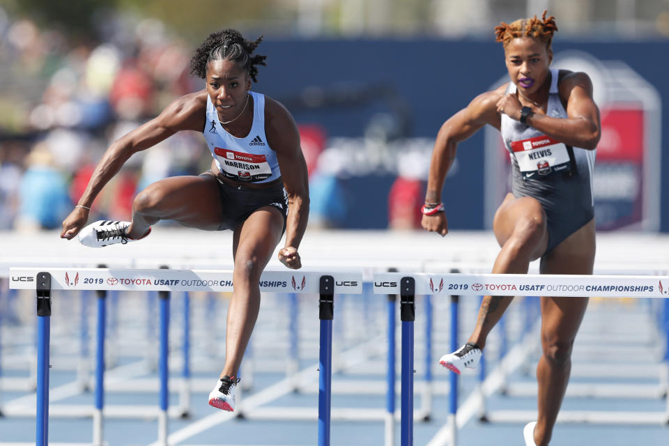 Keni Harrison clears the final hurdle ahead of Sharika Nelvis, right, during a preliminary heat in the women's 100-meter hurdles at the U.S. Championships athletics meet, Friday, July 26, 2019, in Des Moines, Iowa. (AP Photo/Charlie Neibergall)