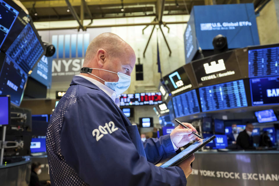 In this photo provided by the New York Stock Exchange, trader Patrick Casey works on the floor, Friday, Jan. 21, 2022. Inflation fears and concerns about the impact of higher interest rates have prompted a cautious shift in the broader market after a solid year of gains in 2021. (Courtney Crow/New York Stock Exchange via AP)