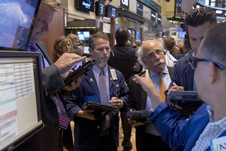 Traders work on the floor of the New York Stock Exchange in New York, United States, July 2, 2015. REUTERS/Brendan McDermid