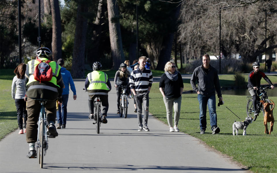 People are seen walking and riding bikes outside. Source: AAP