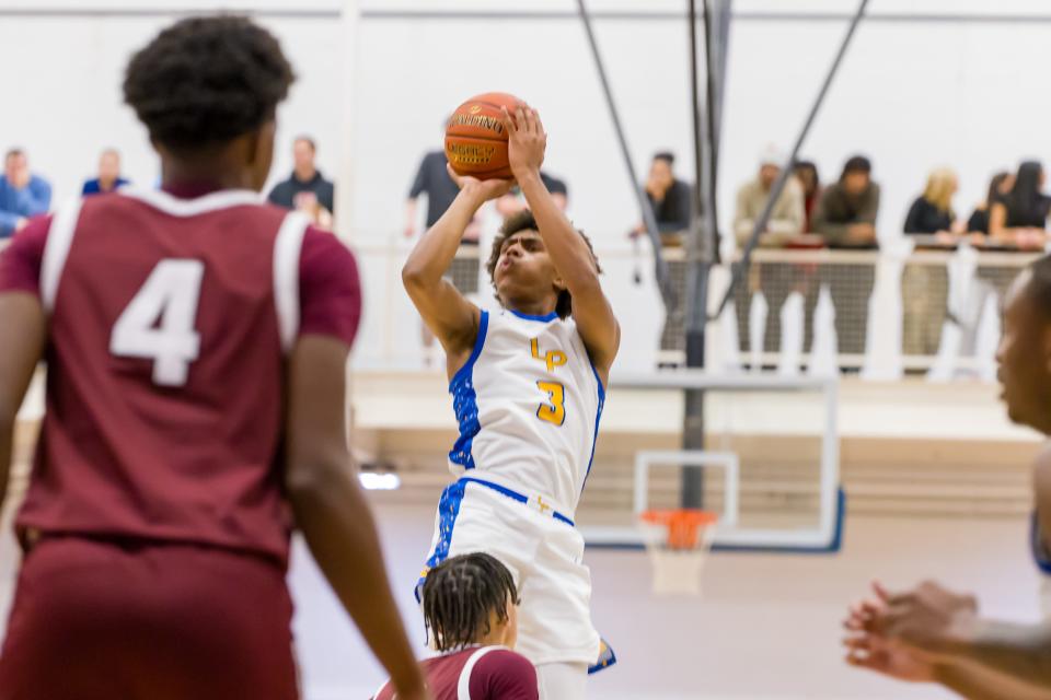 Brandin Cummings (3) takes a shot from beyond the arc during Lincoln Park's second round PIAA Playoff matchup against Uniontown Tuesday night at Canon McMillan High School.