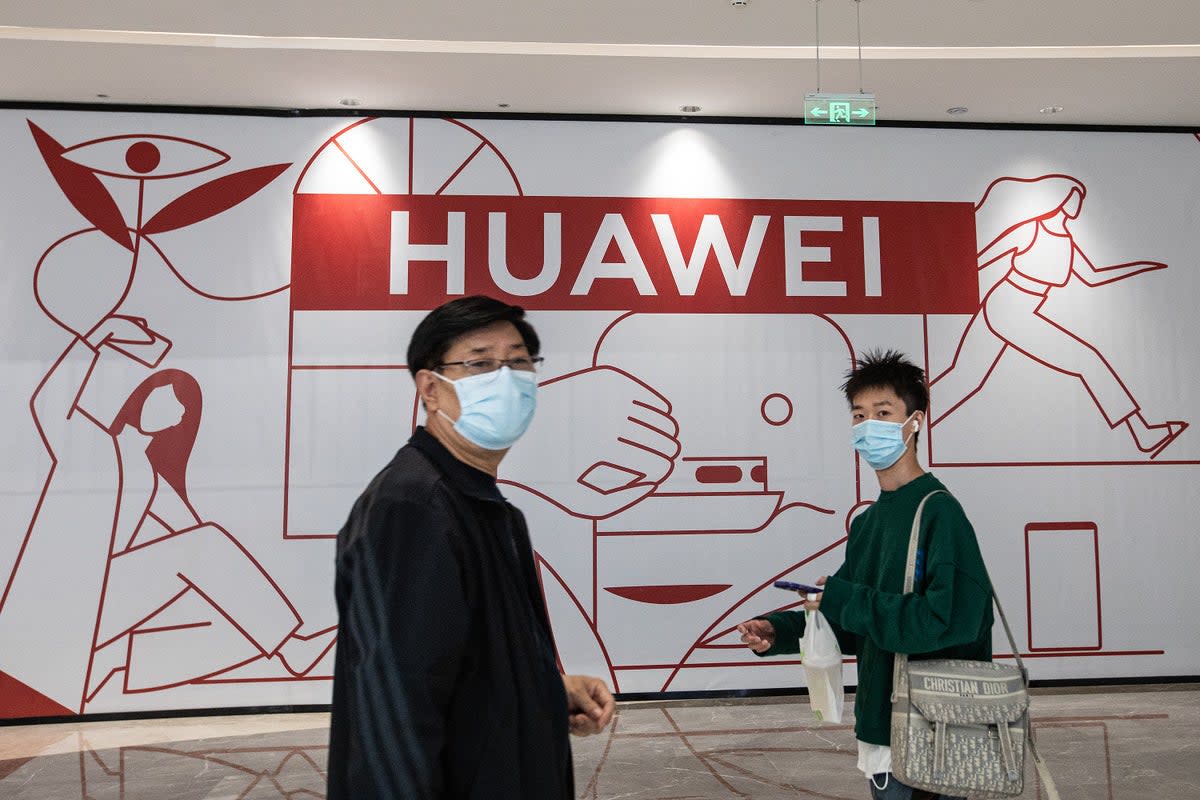 Visitors walk past a Huawei store preparing to open at the Wushang Dream Plaza mall in Wuhan, China  (Getty Images)