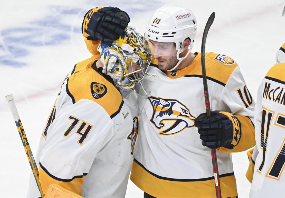 Nashville Predators goaltender Juuse Saros (74) celebrates with teammate Colton Sissons (10) after defeating the Montreal Canadiens in an NHL hockey game in Montreal, Sunday, Dec. 10, 2023. (Graham Hughes/The Canadian Press via AP)