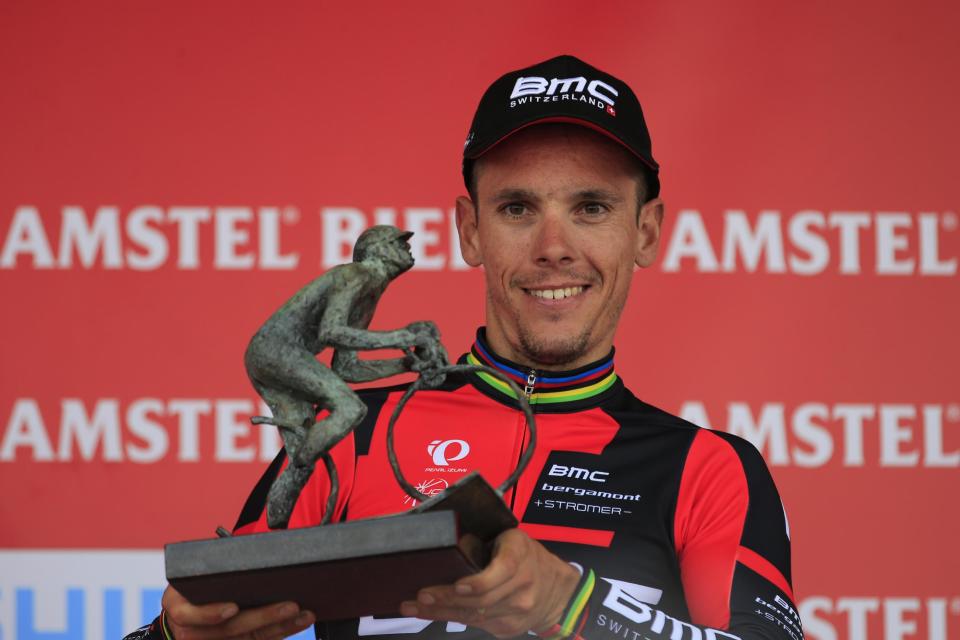 Belgium's Philippe Gilbert holds the trophy on the podium after winning the 49th edition of the Amstel Gold Cycling Race over 251.8 kilometers (156.5 miles) with start in Maastricht and finish in Valkenburg, southern Netherlands Sunday, April 20, 2014. (AP Photo/Peter Dejong)