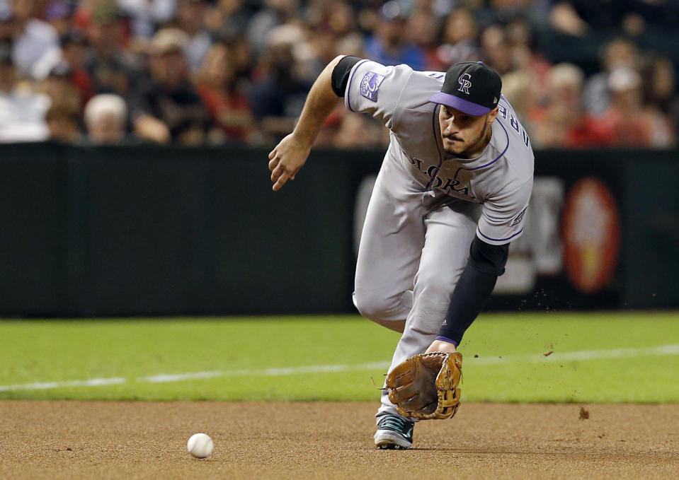 File-This Sept. 21, 2018, file photo shows Colorado Rockies third baseman Nolan Arenado in the first inning during a baseball game against the Arizona Diamondbacks in Phoenix. Arenado likes where he's at and the direction the Colorado Rockies are headed. So he's staying put. For possibly a long, long time. And for a chance to finish what this team has been brewing. The All-Star third baseman agreed to a $260 million, eight-year contract on Tuesday, Feb. 26, 2019, a person familiar with the negotiations told The Associated Press. The person spoke on condition of anonymity because the deal has not been finalized. (AP Photo/Rick Scuteri, File)