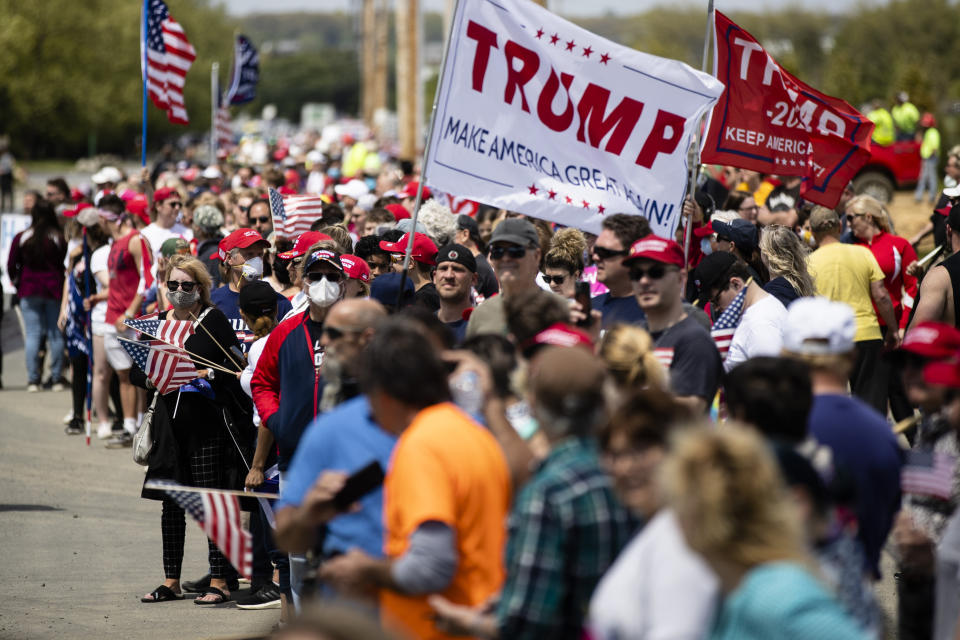 People line the side of the road waiting for the motorcade with President Donald Trump to drive past on Thursday, May 14, 2020, in Allentown, Pa. (AP Photo/Matt Rourke)