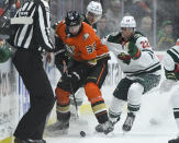 Anaheim Ducks center Derek Grant (38) and Minnesota Wild left wing Kevin Fiala (22) vie for the puck during the second period of an NHL hockey game Friday, Oct. 15, 2021, in Anaheim, Calif. (AP Photo/John McCoy)