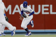 Los Angeles Dodgers center fielder Mookie Betts drops a fly ball hit by Texas Rangers' Isiah Kiner-Falefa for an error during the third inning of a baseball game in Los Angeles on Saturday, June 12, 2021. (AP Photo/Alex Gallardo)