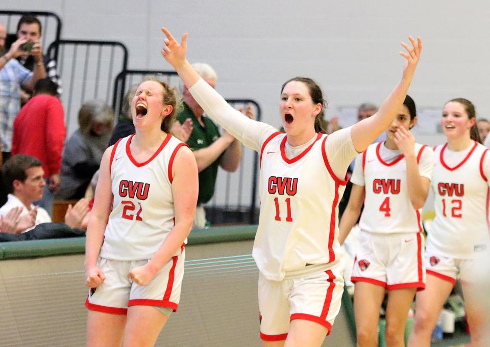 CVU's Grace Thompson (21) and Elise Berger (11) celebrate after the Redhawks 38-33 win over St. Johnsbury the 2024 D1 State Championship game at UVM's Patrick Gym.