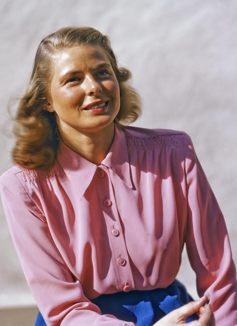 Bergman posing for a portrait in a pink blouse.&nbsp;