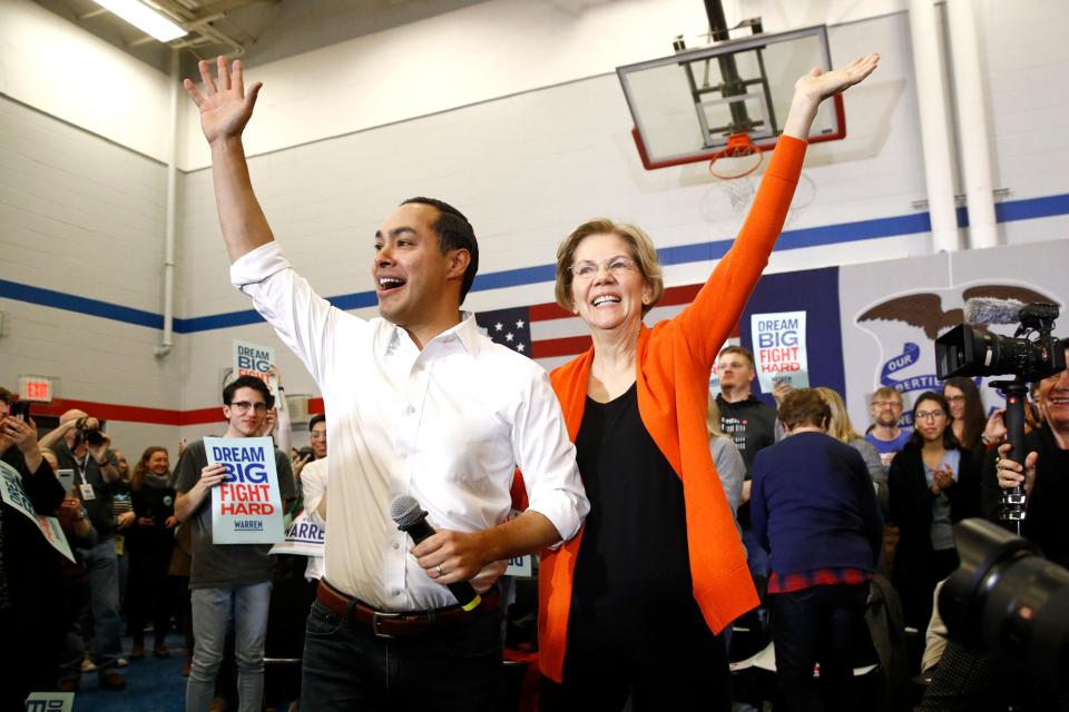 Former Secretary of Housing and Urban Development Julian Castro, left, stands with Democratic presidential candidate Sen. Elizabeth Warren, D-Mass., after introducing her during a campaign event, Sunday, Jan. 12, 2020, in Marshalltown, Iowa.