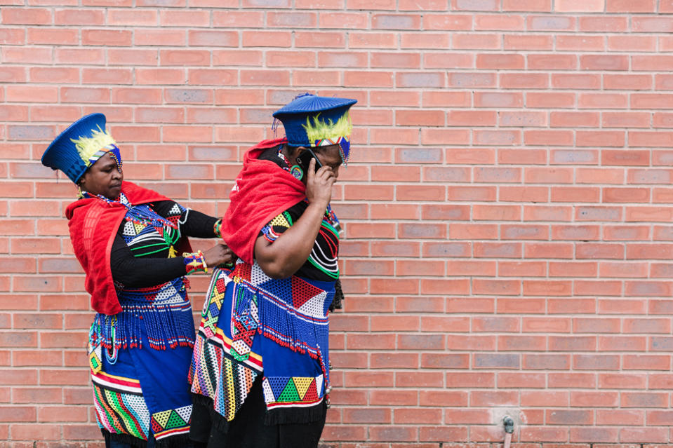 Women clad in their traditional outfits get ready take part in the Indoni SA Cultural Festival in the town of Richmond, outside of Durban, on December 16, 2023. The Indoni festival, a three-day feast, showcases traditions of South African provinces and aims to demonstrate unity and the unique diversity of the country