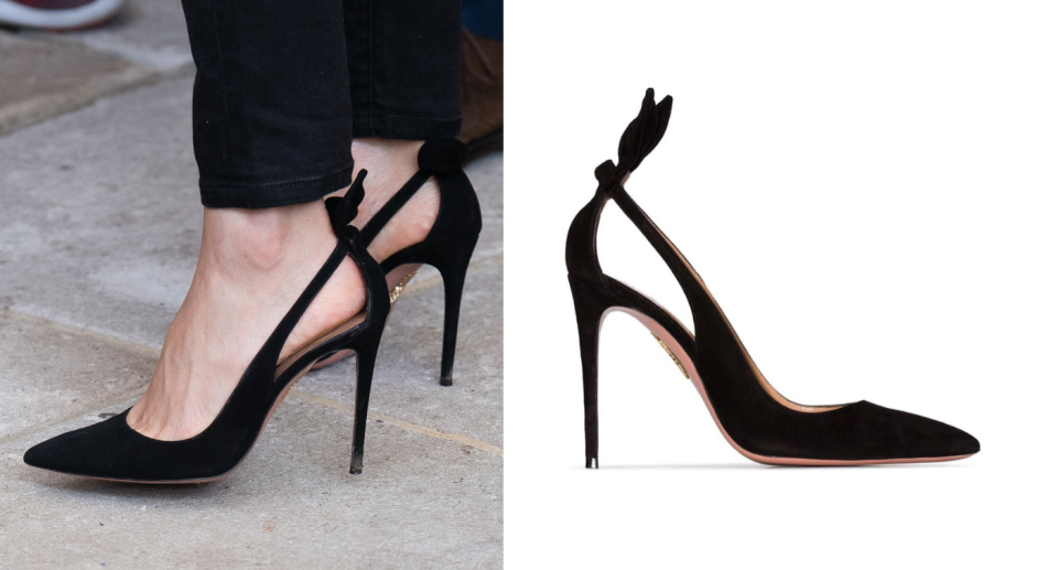 Closeup of Meghan Markle in a pair of black Aquazzura Deneuve pumps.