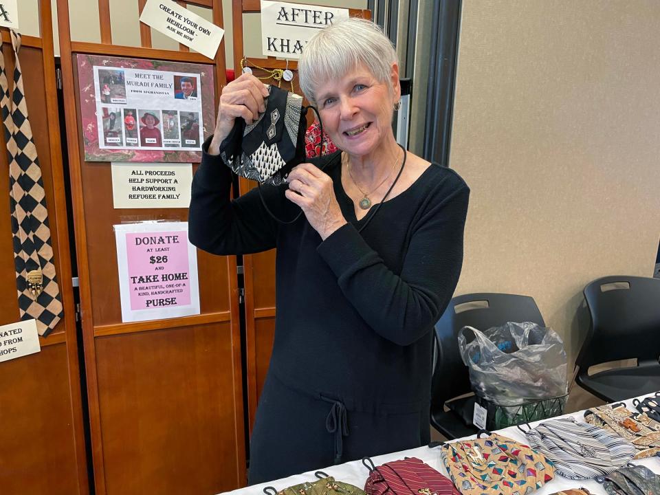 Handbags sewn from neckties by a refugee from Afghanistan are sold by Jan Flint, who joined the annual Spring Craft Show at Karns Senior Center, April 30, 2024