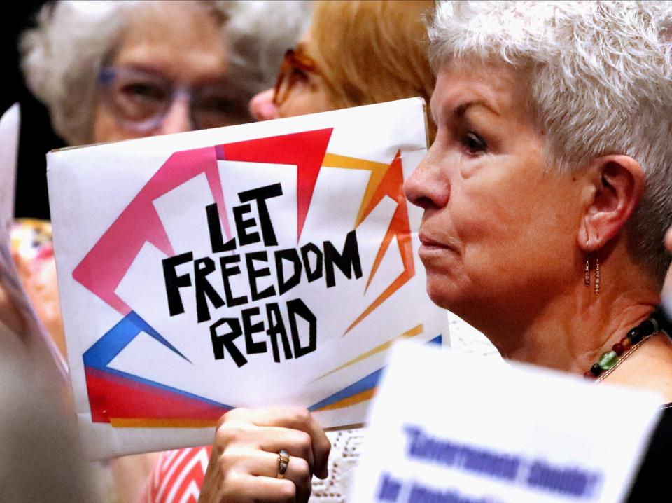 Karen Bingham holds a Let Freedom Read sign during a Rutherford County Library Board meeting on Monday, Aug. 28, 2023, at City Hall where books were banned.