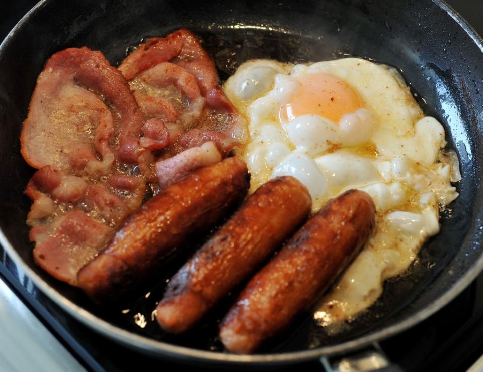 Egg, sausages and bacon being fried in a frying pan (Nick Ansell/PA) (PA Archive)